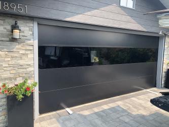Used – 1 – 16x8 black Sterling contemporary door. Solid panels only.